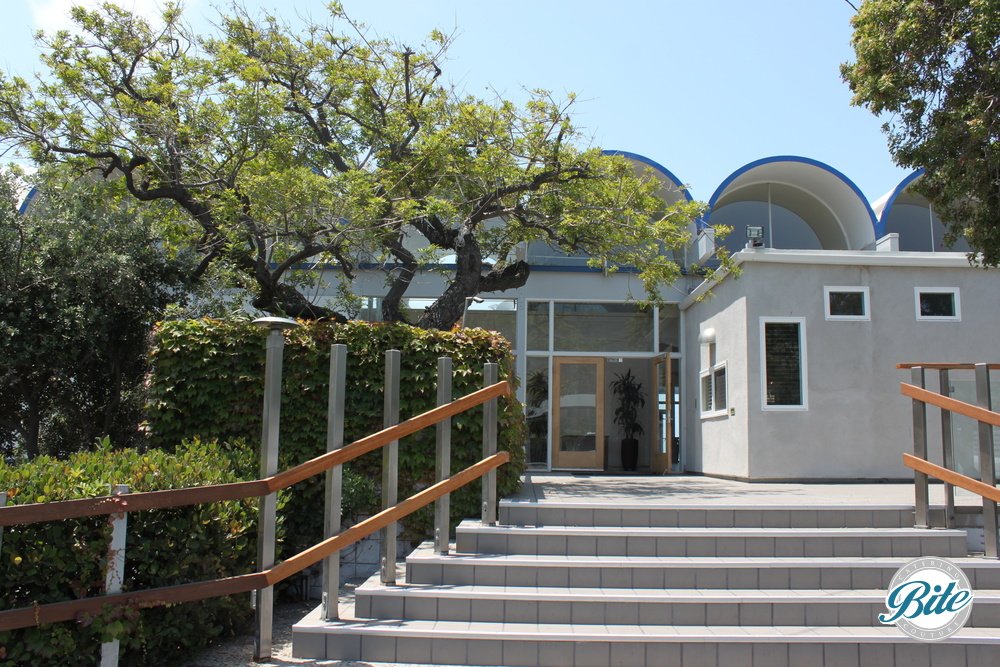 Picturesque entrance to the Malibu West Beach Club. Graceful stairs, trees, and an inviting entryway.