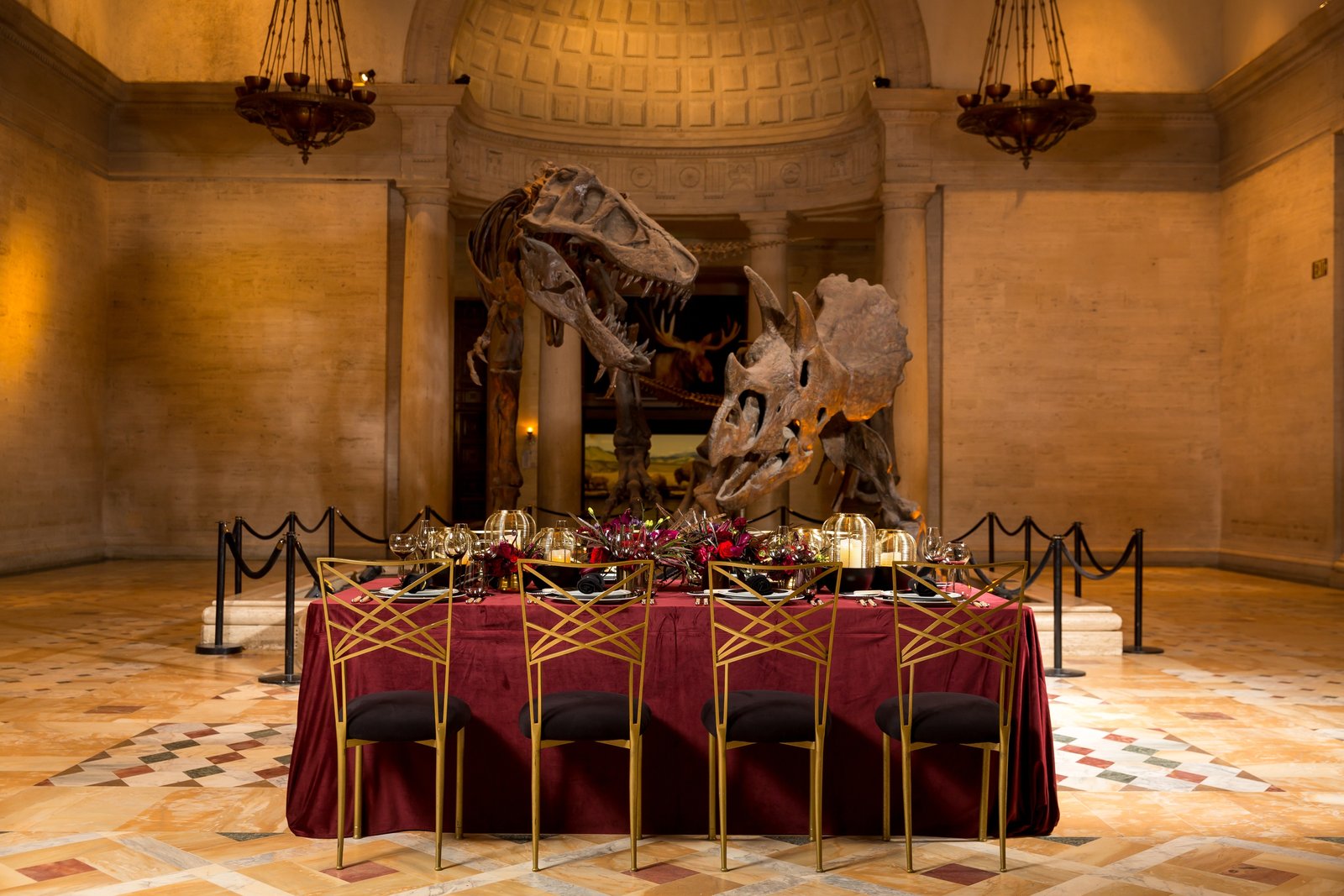 A dramatic battle between dinosaurs serves as the backdrop for a dinner