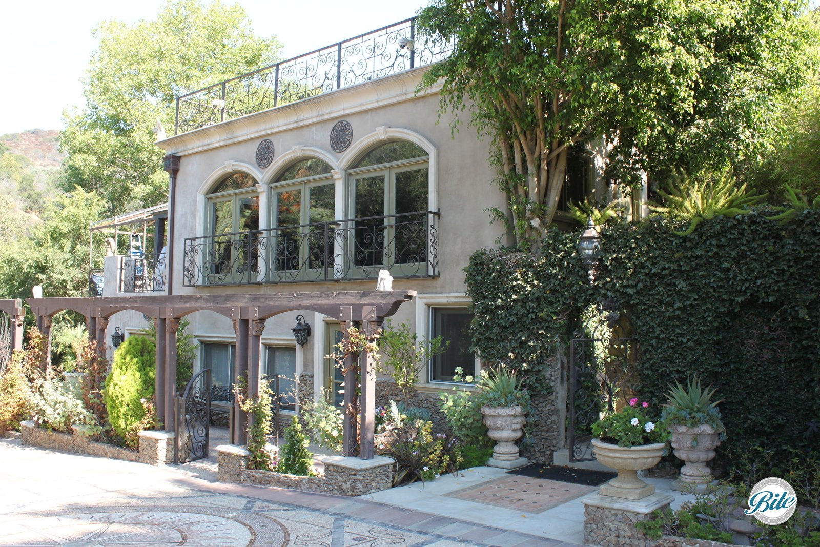 Front of the residence at the Houdini Estate. Gorgeous vines and landscaping meet an elegant building