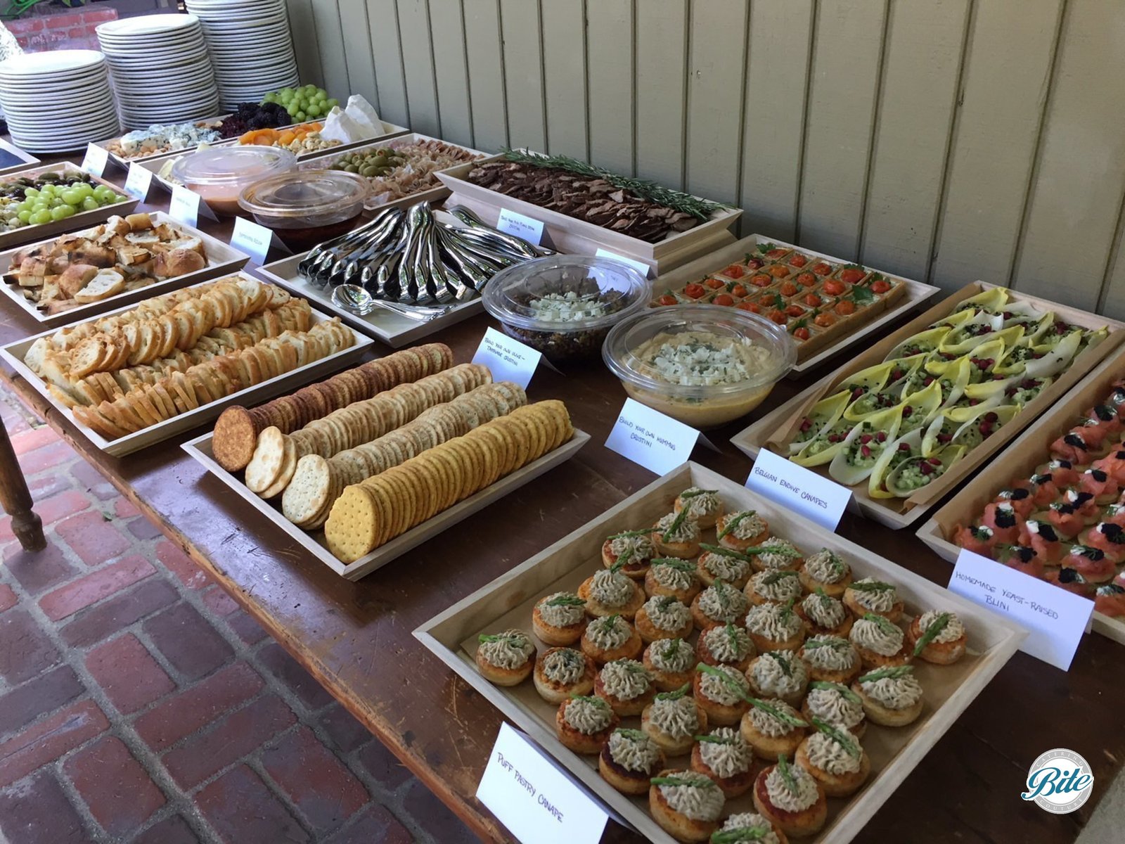 Buffet Table With Appetizers on Wooden Trays