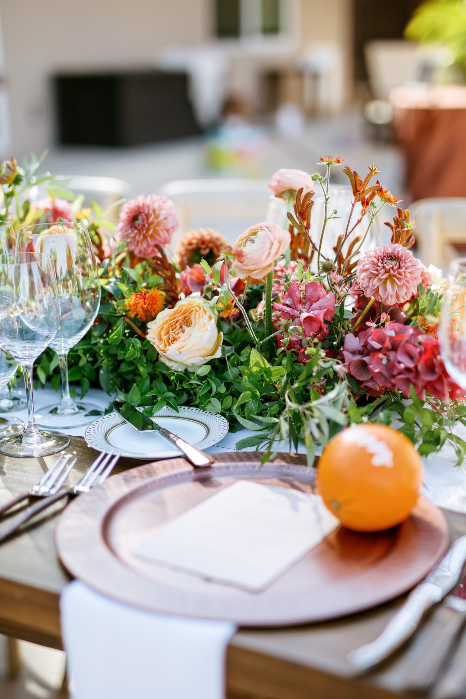 Summer florals burst with color on the wedding reception table