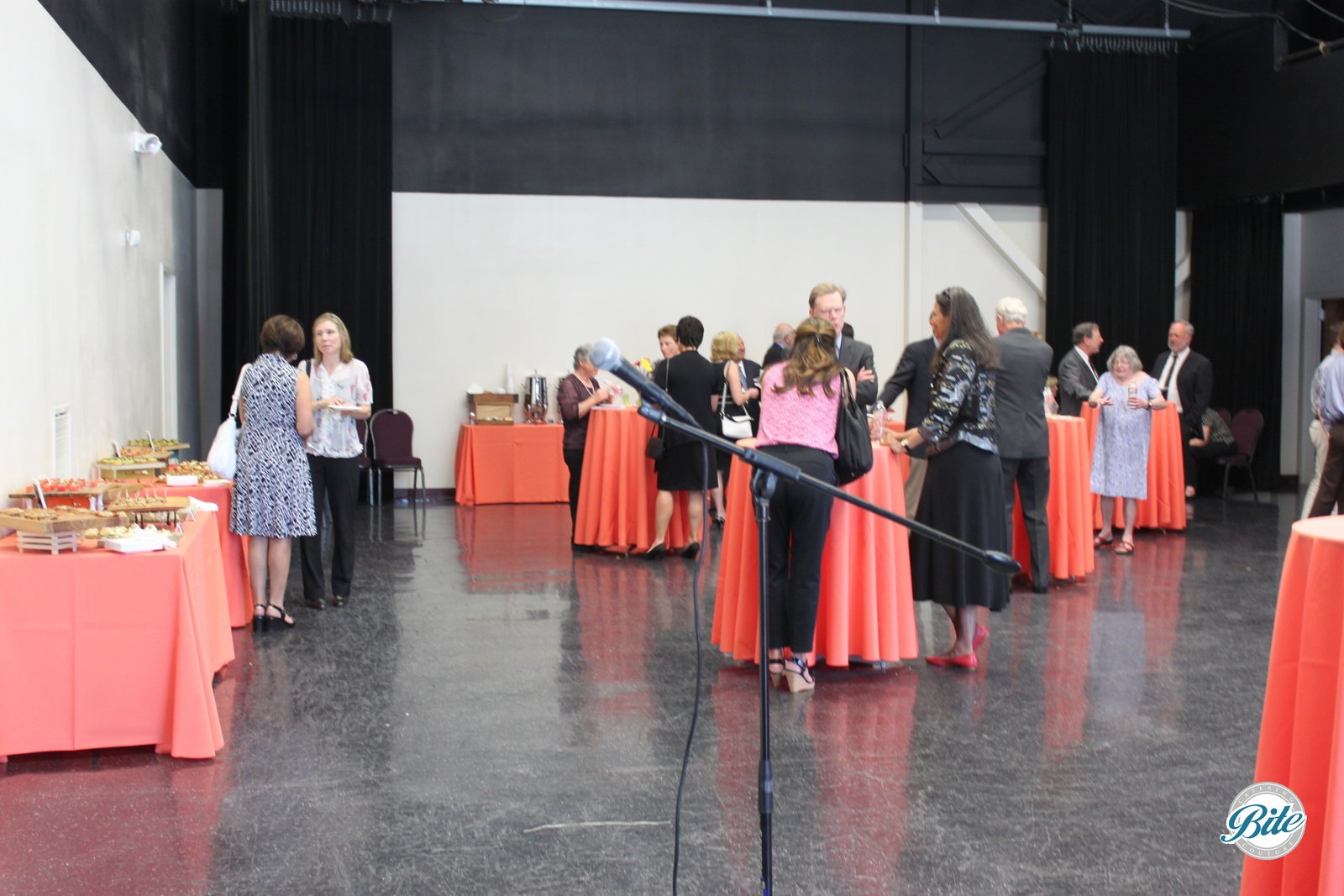 Guests talking amongst cocktail tables