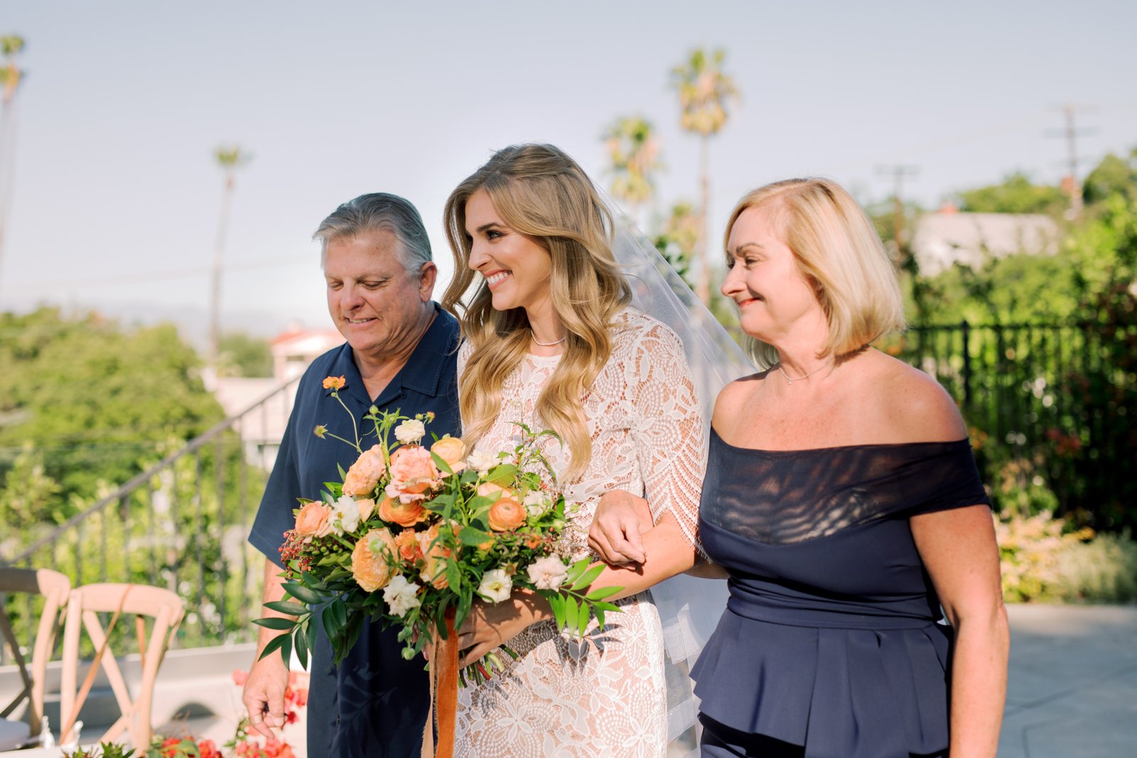 Our beautiful bride is escorted to her handsome groom in the family's backyard