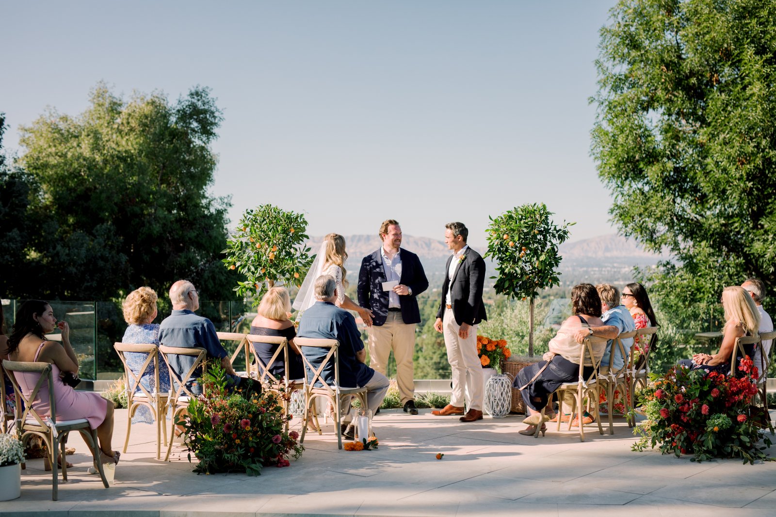 The bride and groom say their vows in front of an intimate gathering of closest friends and family in the bride's backyard of her family home in Woodland Hills