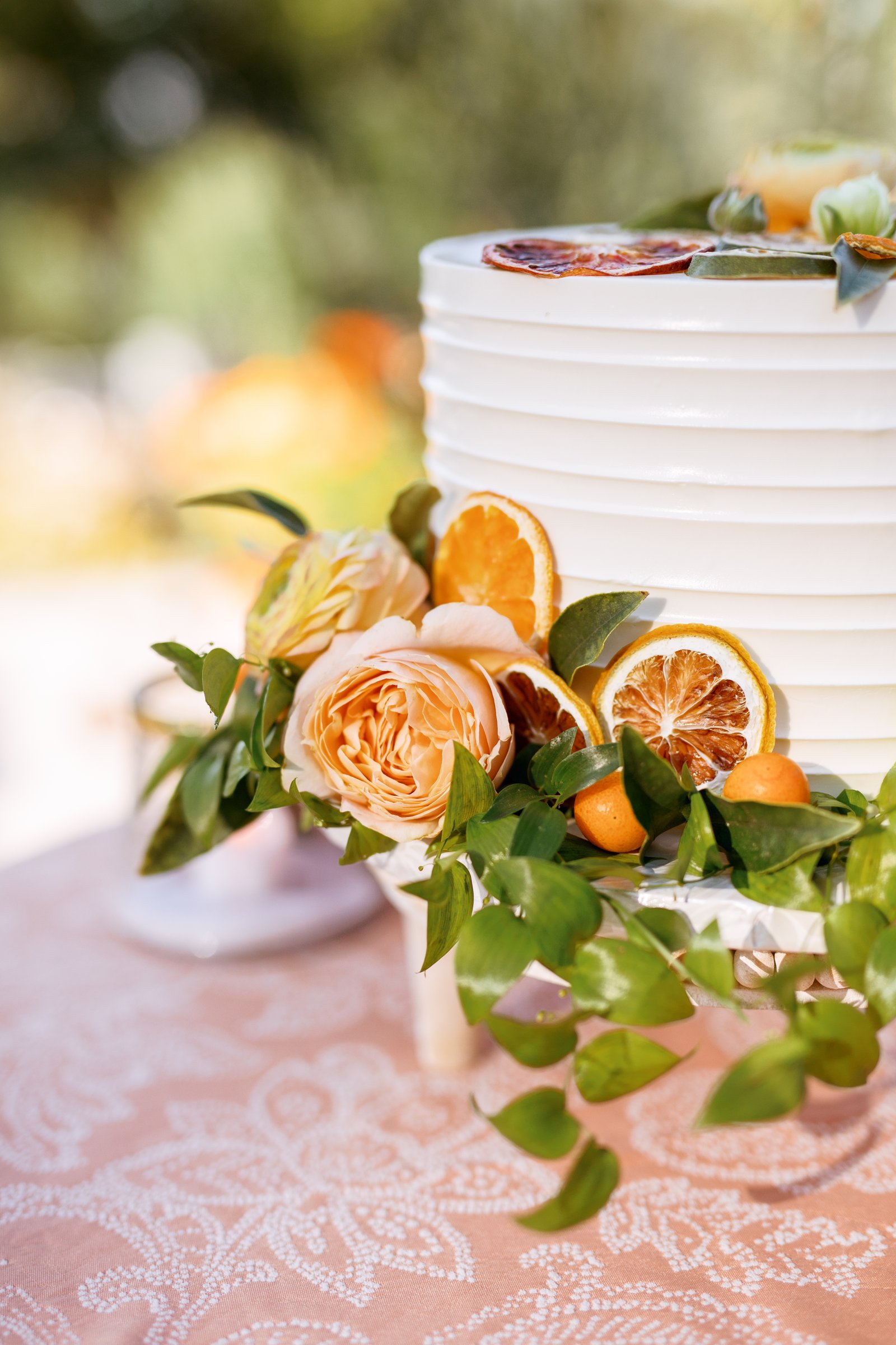 Simply perfect citrus and floral garnished custom buttercream wedding cake