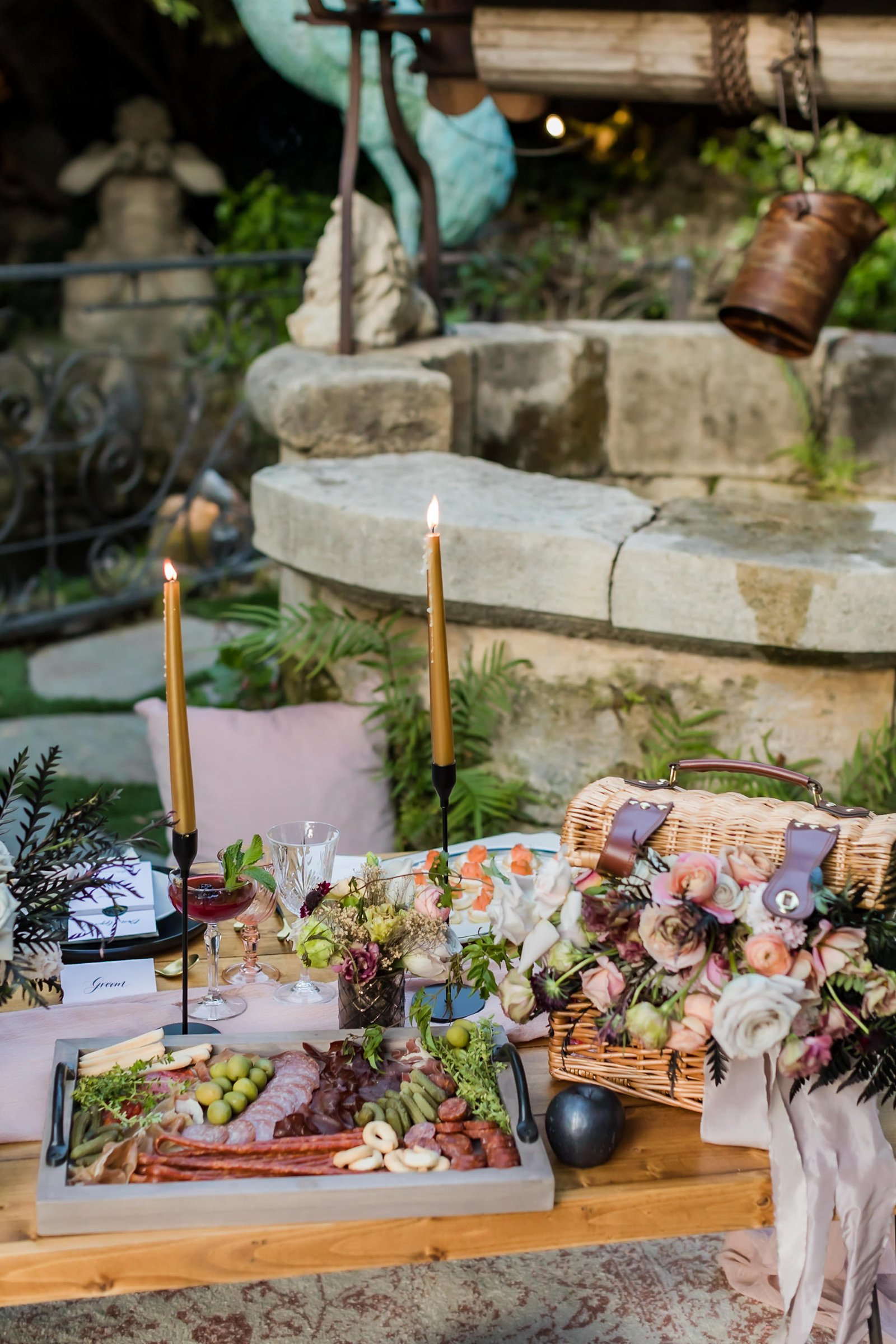 Picnic inspired tablescape with custom picnic basket, summer florals and charcuterie